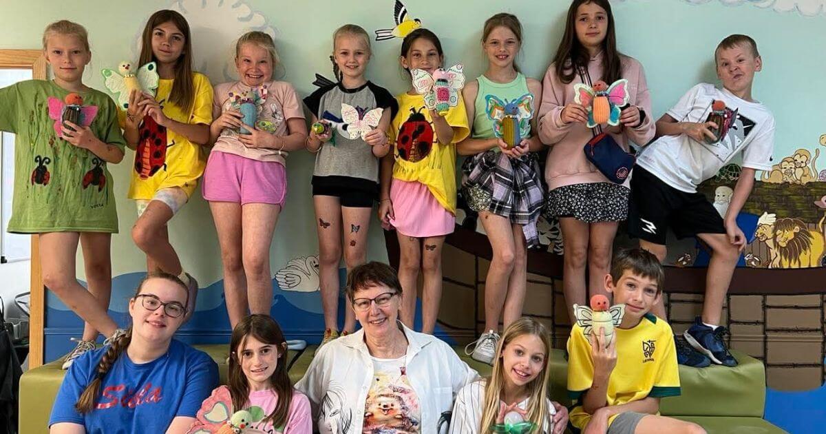 Children holding handmade camp projects at Siela Summer Camp 2025